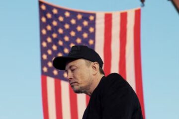 elon musk in front of american flag